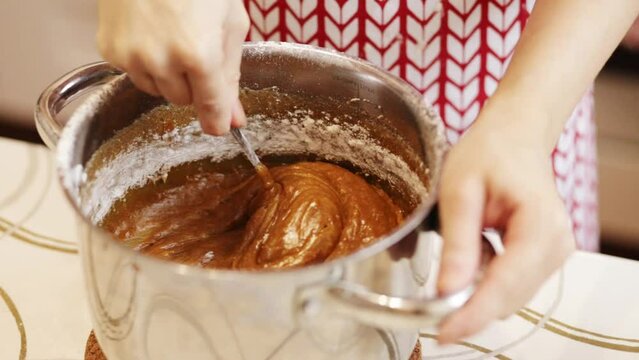 Cooking Christmas dessert is gingerbread cookies, gingerbread, Women's hands stir the dough