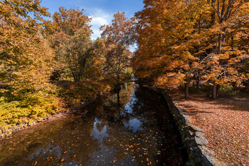 Callicoon Creek, NY, Catskill Mountains, surrounded by brilliant fall foliage on a bright autumn morning
