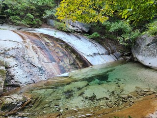 mountain waterfall flows into a clear transparent mountain lake. hiking in korean mountains - Bukhansan - Mangwolsa Temple - Dobongsan