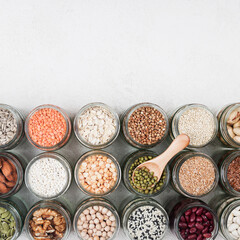 Fototapeta na wymiar Vegan source of protein. healthy vegetarian food. top view of seeds, nuts, peas, beans, spelt, oatmeal on white background copy space square