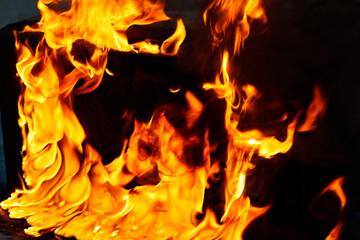 fire and molten plastic on a black background. the concept of fire in the kitchen and malfunctions, breakdowns of electrical appliances and wiring, installation of fire safety systems.