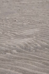 Fototapeta na wymiar Texture of beach sand that make a wave pattern