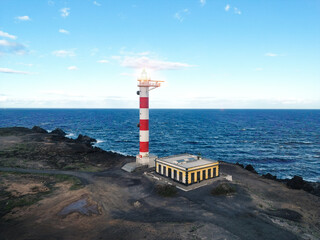 Beautiful aerial view of an illuminated lighthouse on the coast. Abona Lighthouse, Tenerife