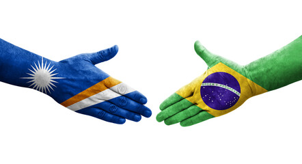 Handshake between Brazil and Marshall Islands flags painted on hands, isolated transparent image.