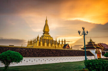 Laos Travel Landmark, Golden Chedi, Wat Phra That Luang at sunset in Vientiane