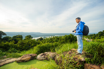 Man Traveler with photo camera and backpack hiking, Adventure concept.