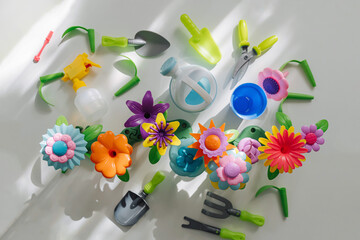 Colorful Flower garden toys and planting tools on white table. Garden themed toys for kids. Pretend play, Montessori activity