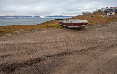 A lone fishing boat on the edge of the Arctic Ocean at the village of Pond Inlet, Nunavut