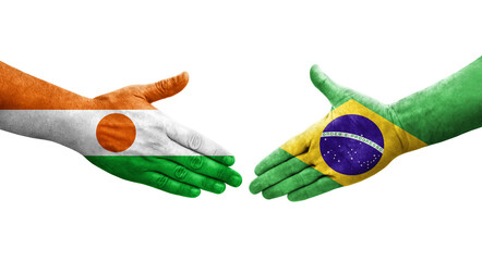 Handshake between Brazil and Niger flags painted on hands, isolated transparent image.