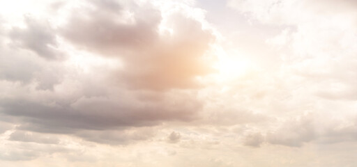 Beautiful sky background. Clouds block the sunlight and shine through