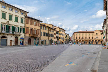 Fototapeta na wymiar The Piazza Marsilio Ficino in Figline Valdarno, Florence, Italy, is still the seat of the market that takes place here every Tuesday morning