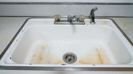 Old white dirty kitchen sink cloce up