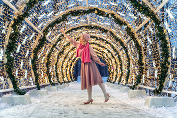 New Year's photos of a beautiful girl in the forest with a decorated Christmas tree, filled with...