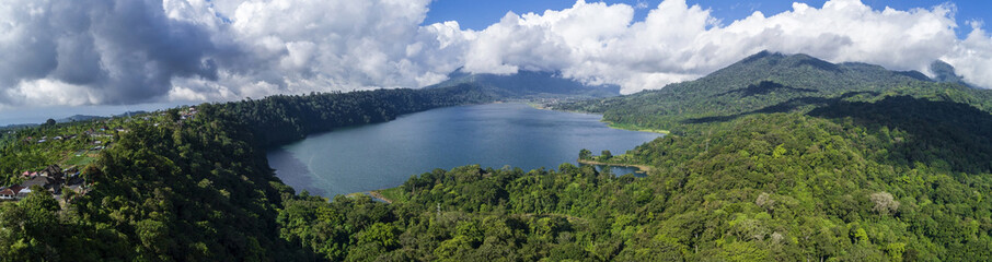 Obraz premium Danau Buyan Lake at High Forestry Hill Under Grey Clouds aerial panorama view