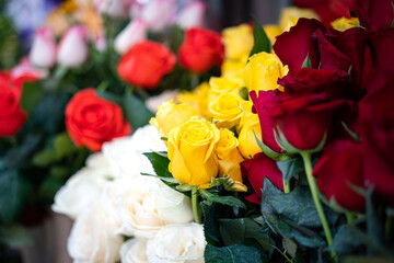 Group of rose flowers petal bouquet which is selling at the flower market, selective focus at the yellow one rose head.
