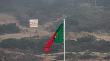 Portuguese flag blowing in the wind, Ribeira d'Ilhas, Portugal