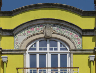 Streets of Lisbon. Detail of traditional Revival facade decorated with colorful flower tiles. Portugal. 
