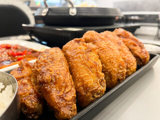Crispy fried chicken wings arranged in a plate on the table, fried chicken Korean style, Korea