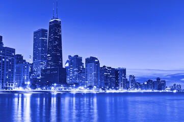 View of Chicago skyline from the shore of Lake Michigan at night.
