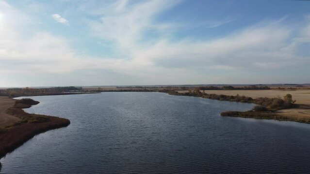 Intact wetlands in a rural area of Saskatchewan, Canada, surround by farmed fields. Late fall. 