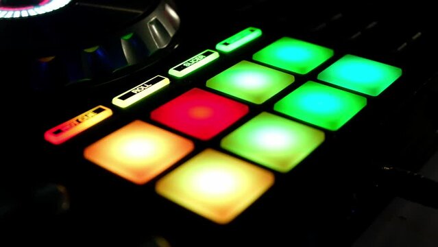 Shimmering with different colors pads of music beat sampler. Digital audio beatmaking machine. DJ audio equipment