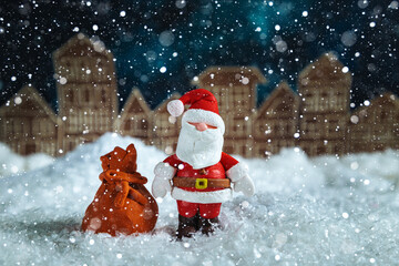 Santa Claus at night in a toy snowy town.