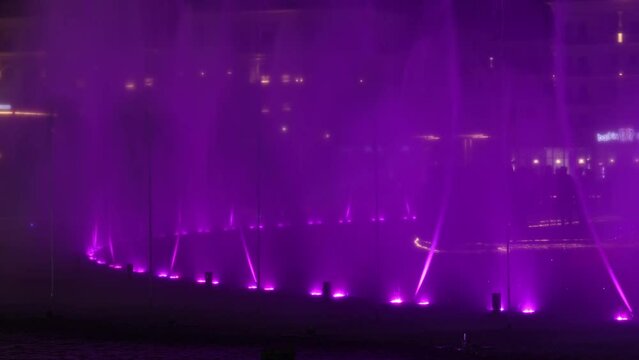Autumn, 2022 - Uzbekistan, Tashkent - Musical fountain in Tashkent City in the evening. People admire the light show of the musical fountain.