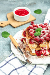 Summer dessert, classic tiramisu with raspberry decorated with mint leaves. vertical image. top view