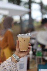Closeup of Iced Caramel Macchiato at the coffee shop, Caramel Macchiato is a classic macchiato beverage. It consists of vanilla syrup, espresso, steamed milk, foam, and caramel drizzle