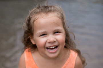  little girl smiles.  happy face of a child. girl is enjoying a walk