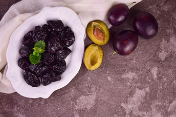 A plate with prunes.Dried plums.Flet ley.Copy space.  © Olivka888