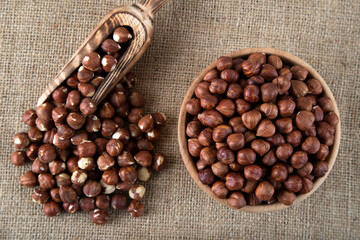 View of a bowl full of hazelnuts on burlap sack