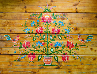 Petrykivka painting on a wooden wall