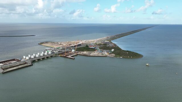 Afsluitdijk construction on pumping stations new sluices and the A7 near Den Oever, Kornwerderzand , and Zurich. Lock for shipping, road traffic cyclists and walkers. Aerial drone view.
