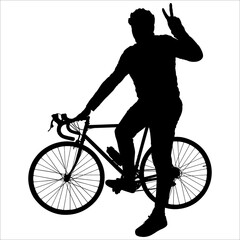Athlete with a bike. A guy in a sports helmet stands near a bicycle; holds the bicycle behind the wheel with his hand; with his other hand he shows the gesture of "victory, peace". The cyclist poses.