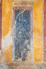 Weathered and aged frescos from the ruins of Pompeii in Italy.