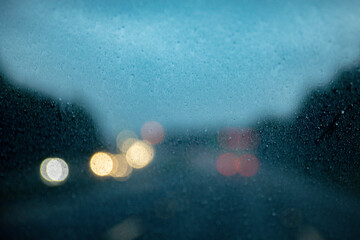 rain on windshield with traffic blurred for effect raindrops background © Jon