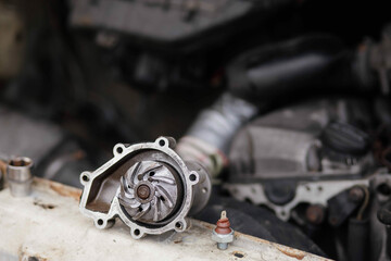 concept of replacing the water pump of the car engine cooling system, a new aluminum car spare part pump.