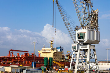 Gibraltar, British Overseas Territory. Harbor and the Bay of Gibraltar with its colorful rail cranes, containers, ships and boats.