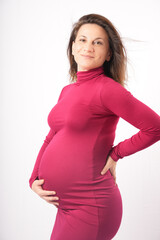 Confident beautiful Beautiful middle aged 30s-40s pregnant woman touching her belly and smiling