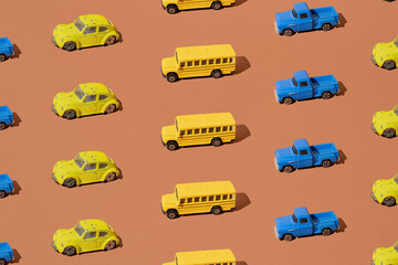 Yellow school bus, blue pickup truck and bug on a brown background. Pattern.