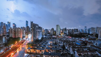 Amazing shot of Shanghai city landscape during night thunderstorm with lightning and cloudy sky