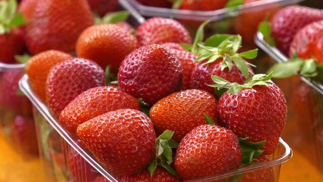 Ripe red strawberries close-up. Strawberries packed in plastic containers. Close up of fresh strawberries