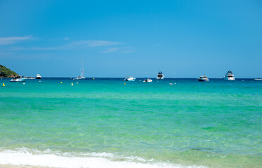 Crystal clear blue water of legendary Pampelonne beach near Saint-Tropez, summer vacation on white sandy beaches of French Riviera, France