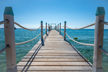 Wooden pier for guests of yachts on legendary Pampelonne beach near Saint-Tropez, summer vacation on white sandy beaches of French Riviera, France