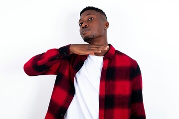 young handsome man wearing plaid red overshirt over white background cutting throat with hand as...