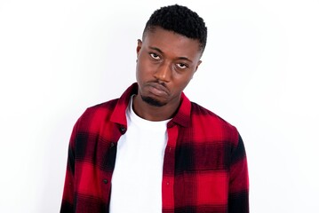 young handsome man wearing plaid red overshirt over white background depressed and worry for...