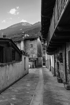 Black and white Photo of a Road without People with Rock Dwellings in Morgex in Aosta Valley, Italy