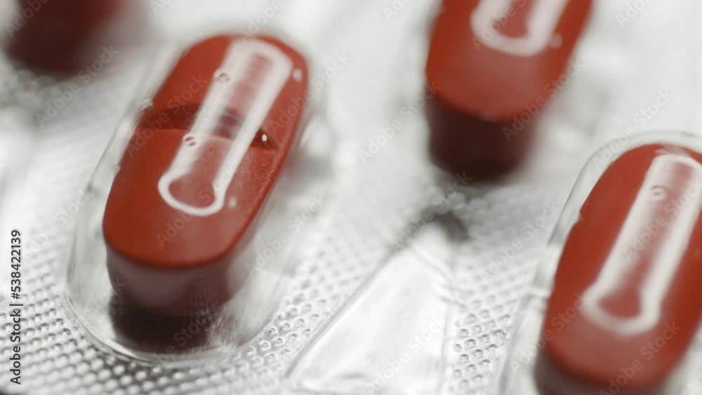Poster red capsules in a blister are rotated in a circle