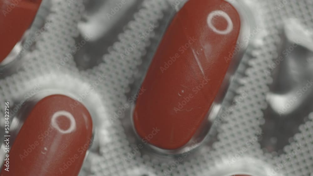 Poster red capsules in a blister are rotated in a circle